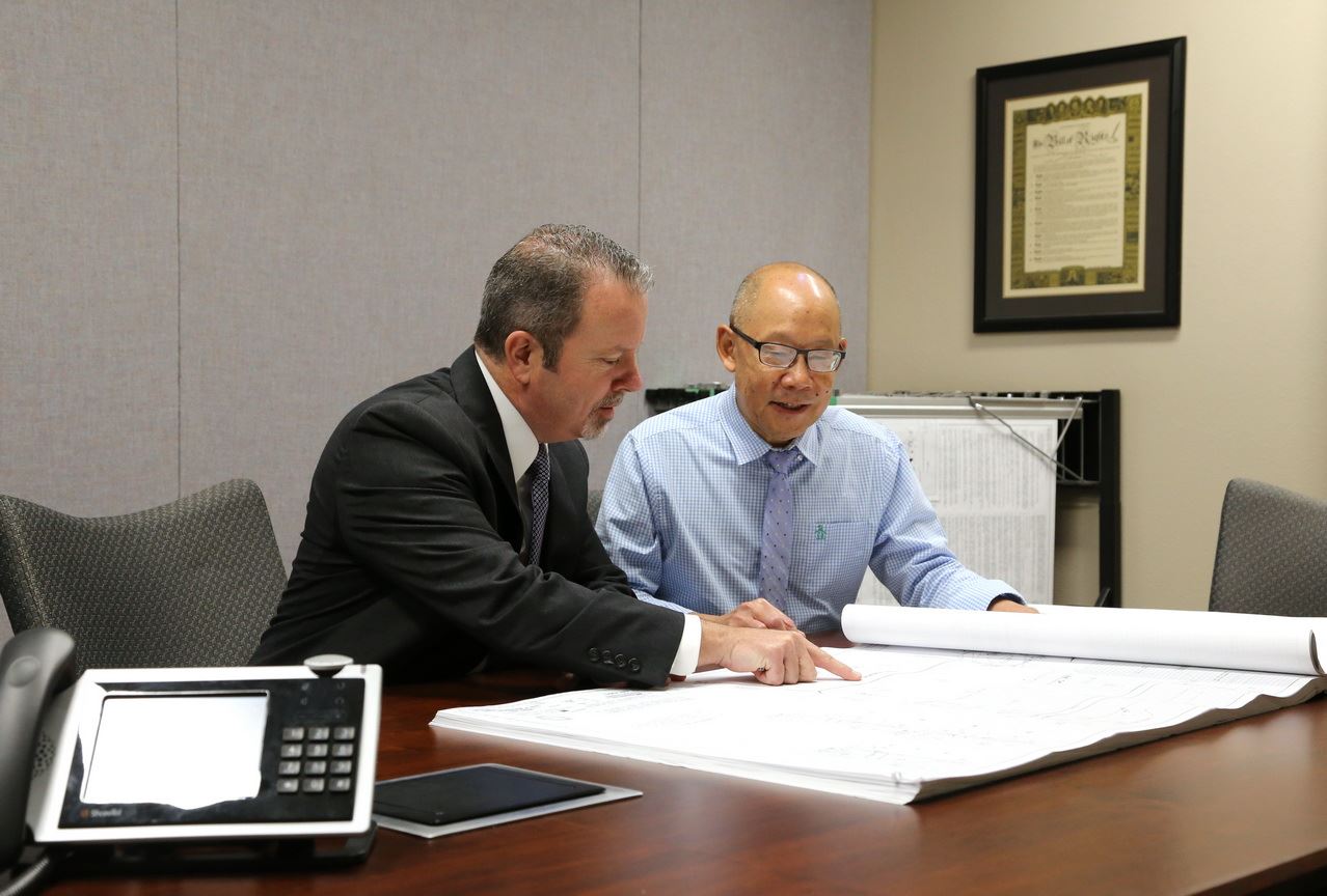 People discussing plans at City Hall