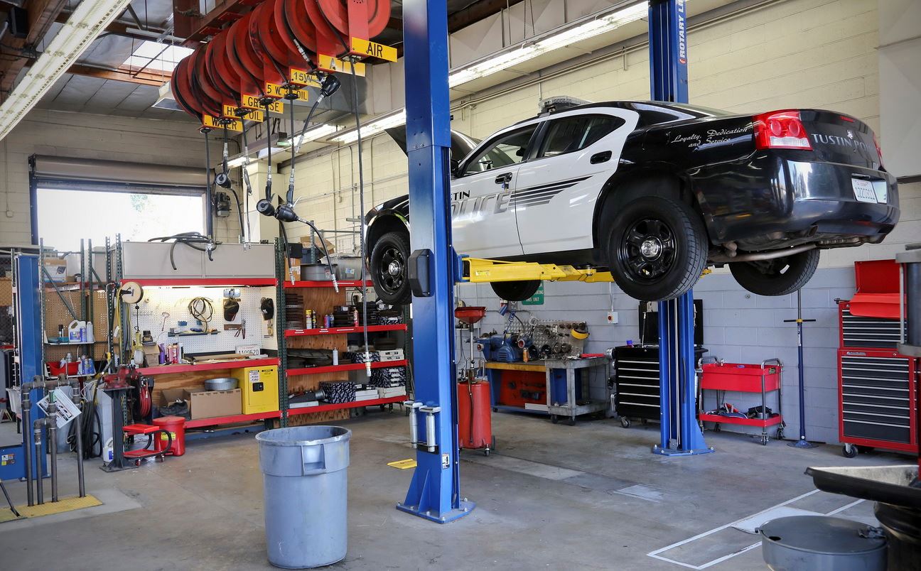 Police vehicle being worked on in garage