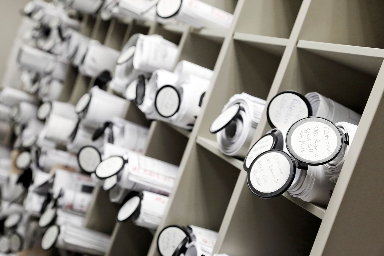 Plans rolled up in storage bins